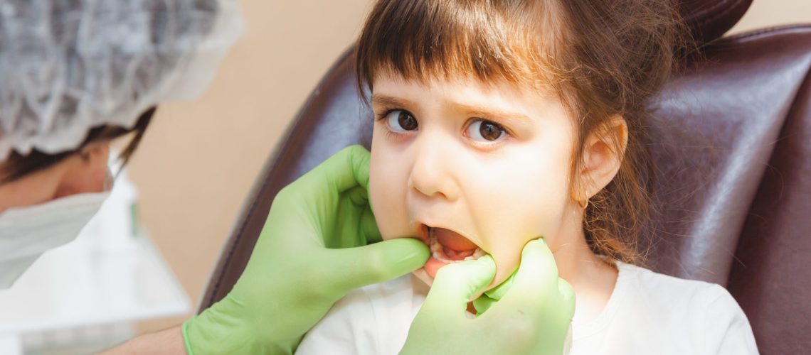 the dentist examines the child s teeth in the dent 2025 03 09 08 51 50 utc